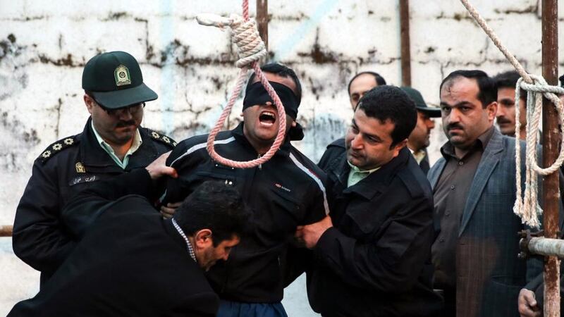 Convicted murderer Balal (C, with blindfold), who was sentenced to death for killing victim Abdolah Hosseinzadeh, shouting for mercy during   his execution in the northern city of Nowshahr, Iran. Media reports state that the execution of 19-year old Iranian murderer Balal was halted in the last minute by the parents of his victim. Photograph: Arash Khamooshi /EPA