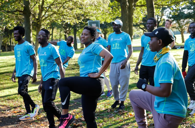 Members of Sanctuary Runners warming up in Fairview Park for training ahead of the Dublin City Marathon. Photograph: Alan Betson 