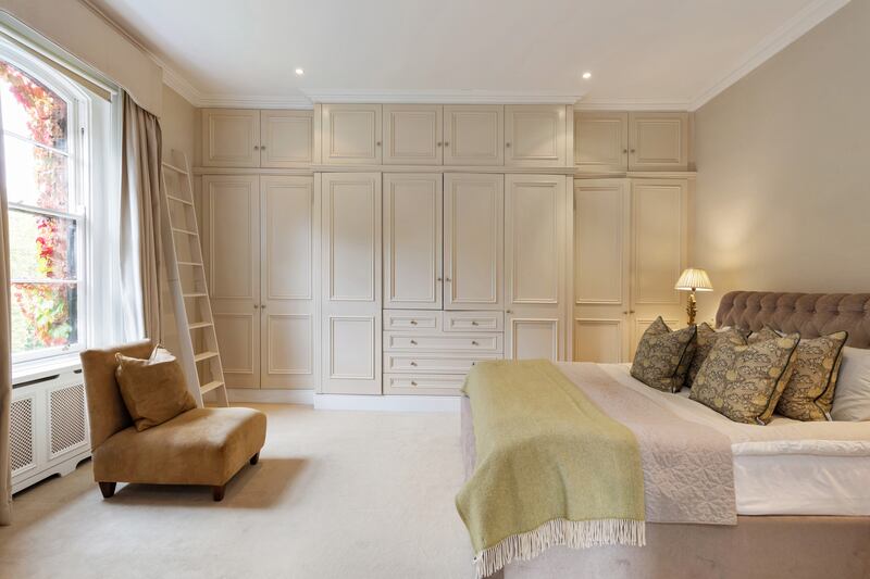 Principal bedroom: a bank of built-in wardrobes.