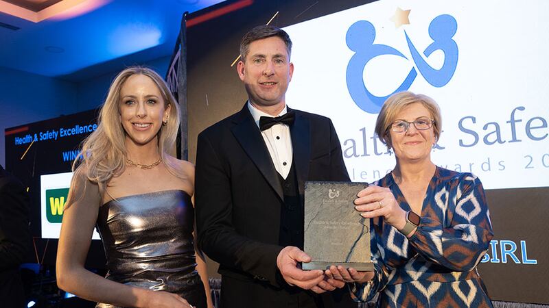 Terry Farrelly, precast director of The O'Reilly Group, presents the health & safety excellence award – retail to Marie Harte & Sinead Conlon, Woodies