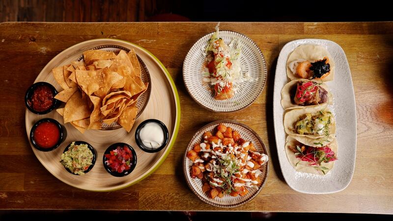 Tortilla chips with dips, taco dorado, papas fritas, and beef, pork, tempura prawn, and chicken taco at Taco Libre. Photograph: Alan Betson