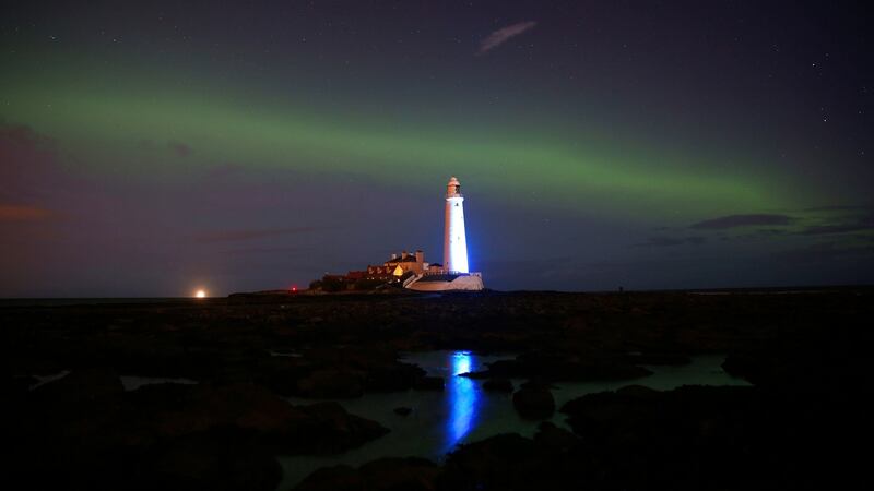 The Northern Lights, or Aurora Borealis, shine over St Mary’s Lighthouse on the English northeast coast at Whitley Bay. Photograph: Owen Humphreys/PA Wire.