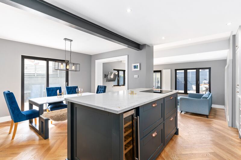 An island creates a divide between kitchen and dining areas