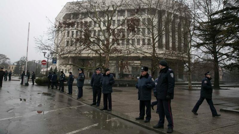 Ukrainian police stand guard in front the Crimean parliament building in Simferopol this morning. Armed men seized the regional government headquarters and parliament today  and raised the Russian flag in a challenge to the country’s new rulers. Photograph: Reuters
