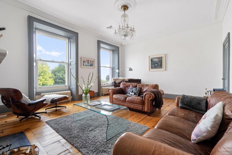 Livingroom upstairs has two fine windows with views of Dublin Bay