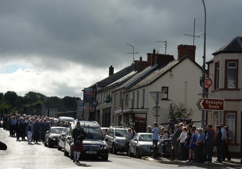 A piper leads the funeral of Seamus Heaney through Bellaghy in 2013. Photographer: Dara Mac Dónaill