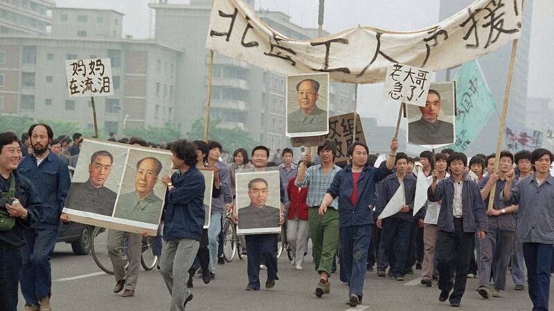 Pro-democracy demonstrators carry portraits of former Chinese rulers Mao Tse-Tung and Chou En-Lai as they march to join student strikers at Tiananmen Square in June 1989. Photograph: Sadayuki Mikami