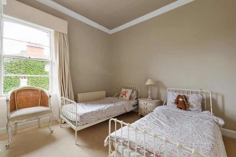 Third bedroom with sash window and cornicing.