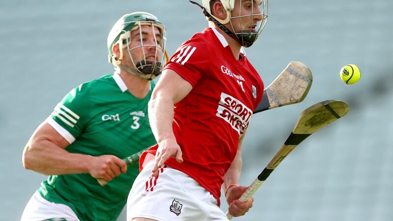 Cork’s Shane Kingston solos ahead of Limerick’s Sean Finn. Photograph: James Crombie/Inpho