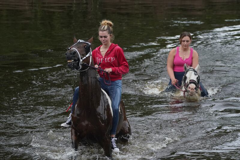 People riding horses in water during the Appleby Horse Fair. Photograph: Owen Humphreys/PA 