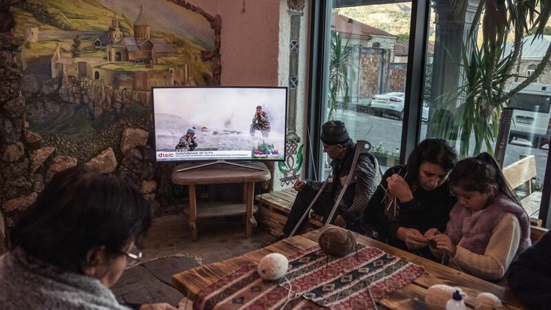Refugees who fled the recent fighting in t Nagorno-Karabakh pass the time in a hotel lobby in Goris, Armenia. Photograph: Sergey Ponomarev/New York Times