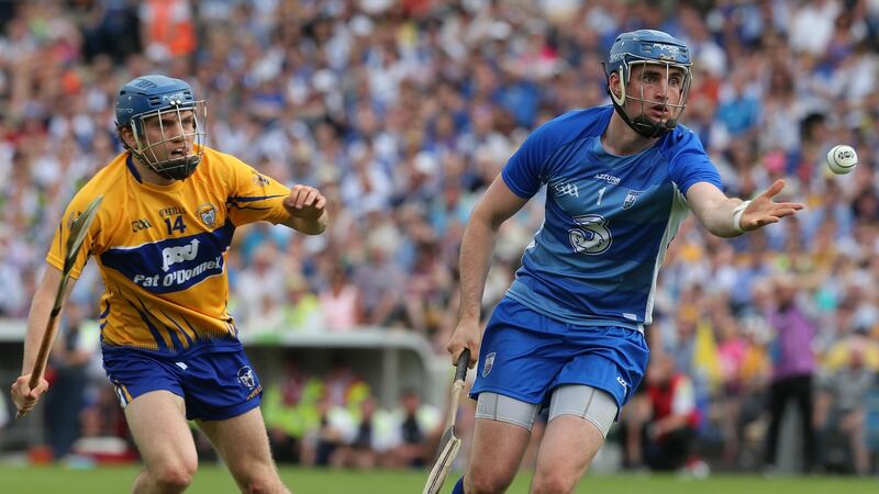 Waterford’s Stephen O’Keefe clears from Clare’s Shane O’Donnell at Thurles.   Photograph: Lorraine O’Sullivan/Inpho