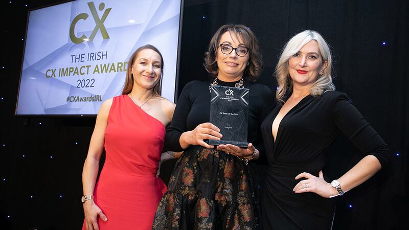 Agnieszka Anna Jozwiak, awards judge, presents the CX Team of the Year award to Elaine Forsythe and Kate Zanchetta, Imagine.