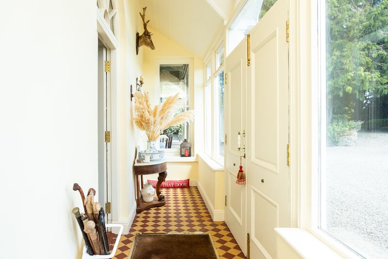 A lovely tiled porch leads to the inner hallway 