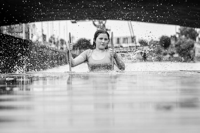 A local girl emerges from the water after a dive and a swim at Spencer Dock 2022. Photograph: Paul Kelly