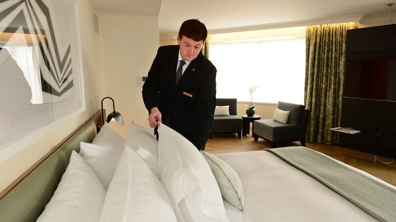 Stephen Molloy, accommodation manager, inspects a bed at the Conrad Hotel, Dublin. Photograph: Dara Mac Dónaill