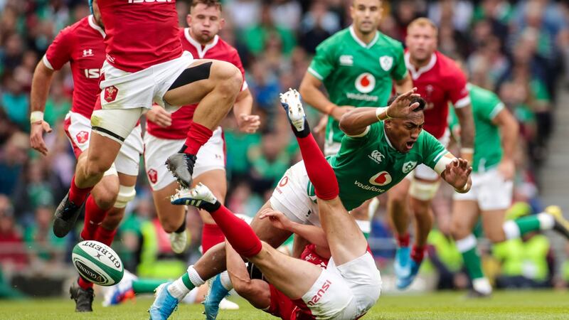 Bundee Aki is tackled by Jonathan Davies and Leigh Halfpenny. Photo: Billy Stickland/Inpho
