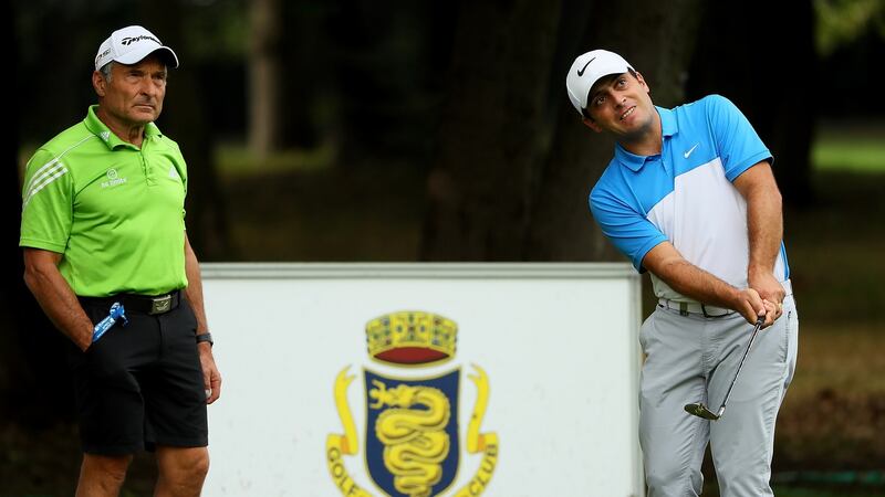 Francesco Molinari warms up on the practice range as his performance coach Dave Alred looks on. Photograph:   Andrew Redington/Getty Images
