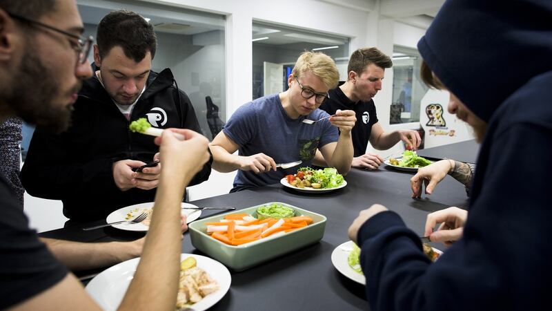 Team Origen eat a dinner of salmon and vegetables at Rfrsh Entertainment’s offices in Copenhagen. Photograph: Pete Kiehart/ The New York Times