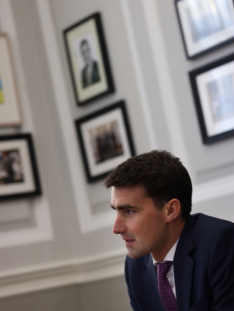 Minister for Finance Jack Chambers photographed at the Department of Finance. On the wall behind him hangs a portrait of former Fianna Fail Finance Minister Brian Lenihan TD. Photo: Bryan O’Brien / The Irish Times





