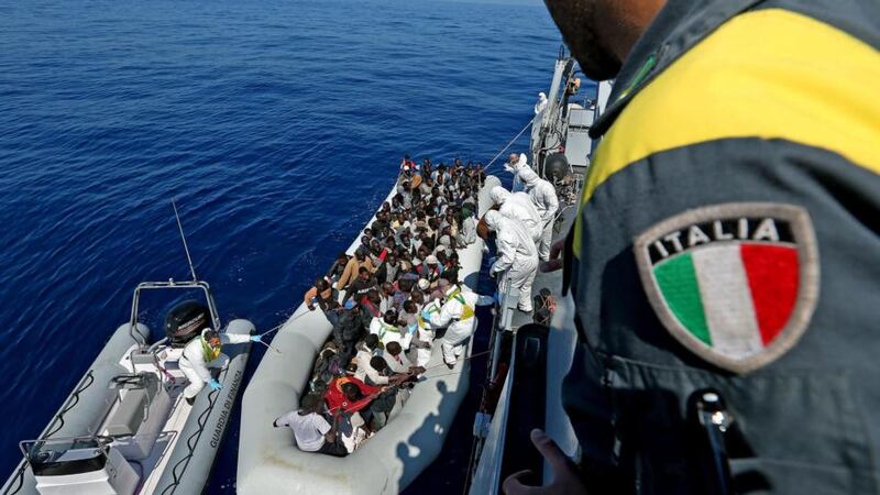 Personnel of the ship P03 ‘Denaro’ of Italian Guardia di Finanza during the transportation operations of hundreds of migrants off the Libyan coast in the Mediterranean Sea on Wednesday. Photograph: EPA
