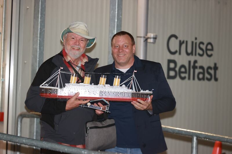 CEO of Villa Vie Mike Petterson with passenger Andy Garrison (left), who built a model of the Titanic during his time in Belfast. Photograph: Liam McBurney/PA Wire