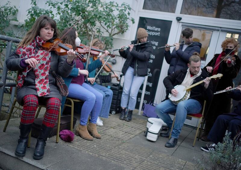 Musicians perform during a vigil outside the London Irish Centre in Camden. Photograph: Dominic Lipinski/PA Wire