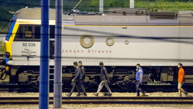 Migrants walk along railway tracks at the Eurotunnel terminal on July 28th. Photograph: AFP