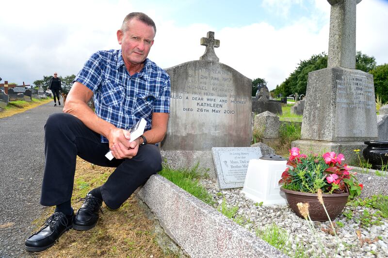 Seamus Kearney pictured at the graveside in Belfast of his brother Michael who was wrongly accused of being an informer and 'executed'  by the IRA in 1979.  Photograph: Arthur Allison/Pacemaker Press.