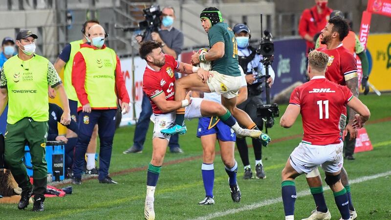 South Africa winger  Cheslin Kolbe is tackled by British and Irish Lions scrumhalf Ali Price during the first  Test match in Cape Town. Photograph:  Rodger Bosch/AFP via Getty Images