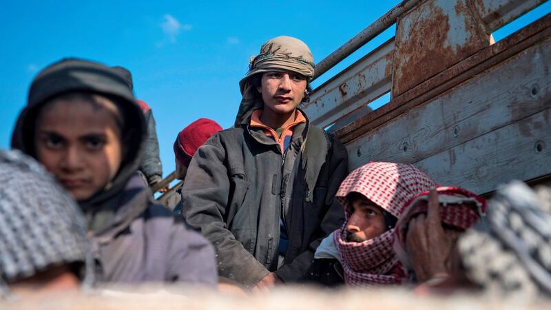 Reported civilians fleeing the battered Islamic State-held holdout of Baghouz in the eastern Syrian province of Deir Ezzor sit in the back of a truck on Monday. Photograph: Fadel Senna/AFP