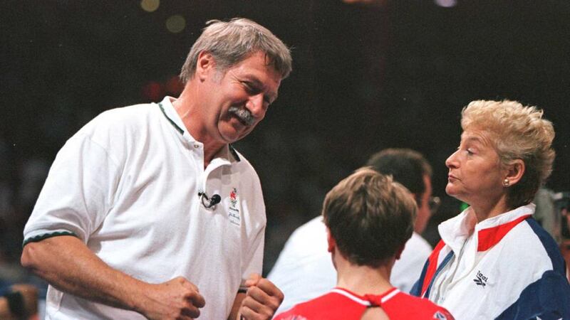 Bela Karolyi (left) and wife Martha Karolyi congratulate Kerri Strug in the US Gymnastics Olympics Trials at the Fleet Centre in Boston in 1996. Photo: Getty Images