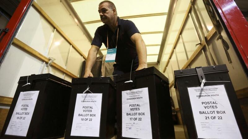A man carries ballot boxes at a counting centre in Edinburgh. Photograph: Paul Hackett/Reuters.