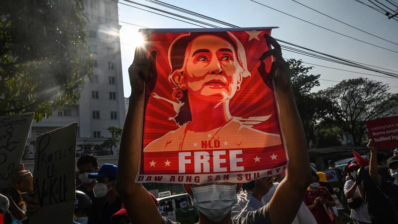 A protester holds up a poster featuring Aung San Suu Kyi during a demonstration against the military coup in Yangon last February. Photograph: AFP via Getty Images