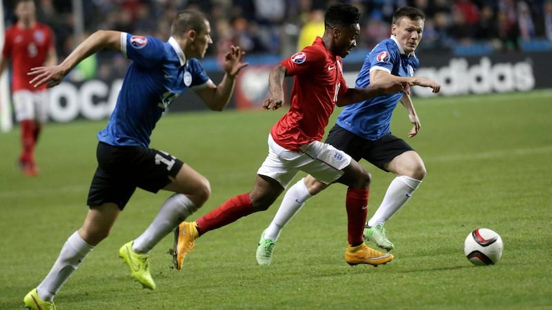 Raheem Sterling dribbles in between Estonia’s Artur Pikk (l) and Dmitri Kruglov (r)  during their Euro 2016 qualifier at the A. Le Coq Arena in Tallinn. Photograph: Ints Kalnins / Reuters
