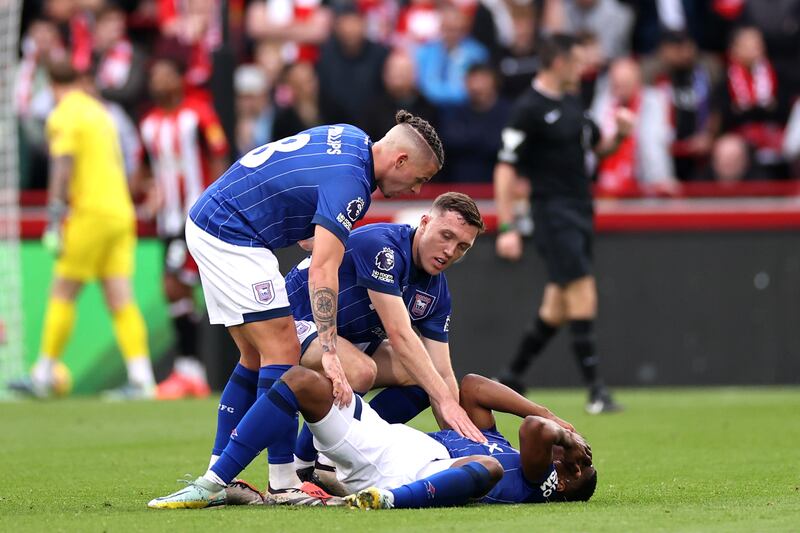 Chiedozie Ogbene is comforted by Ipswich Town teammates Kalvin Phillips (left) and Dara O'Shea after suffering a season-ending injury in a Premier League match against Brentford last October. Photograph: Ryan Pierse/Getty Images)