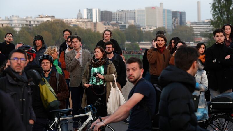 People watch as flames and smoke rise from the Notre Dame cathedral in Paris. Photograph: AP Photo/Thibault Camus