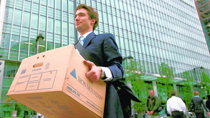 An employee leaves Lehman Brothers with hsi belongings