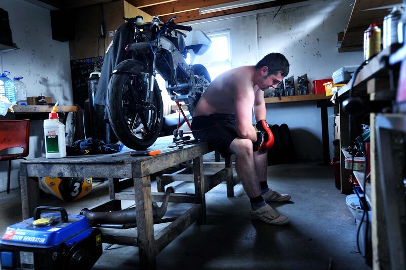 Michael Dunlop takes a break from his boxing training routine  in his garage as he prepares for the 2012 season. Photograph: Stephen Davison
