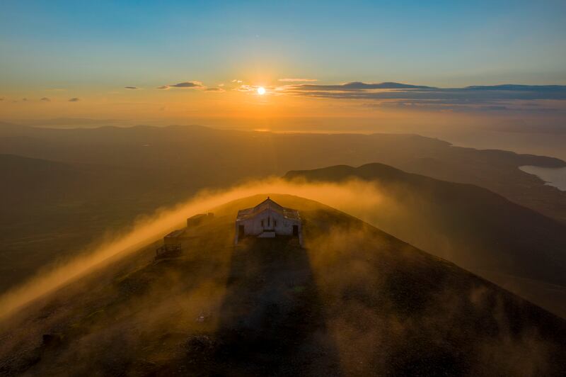 Sunset on the summit of Croagh Patrick: the 764m mountain, like so many other sites of pilgrimage in Ireland, has a pagan history. Photograph: Gareth McCormack/ICP
