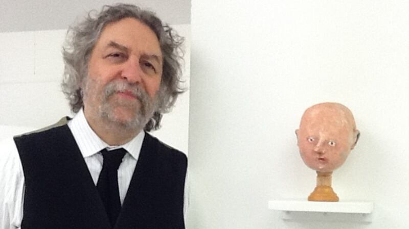 Jamshid Mirfenderesky snapped by Eamonn Mallie in his gallery, with a work by Peter Burns, in 2011