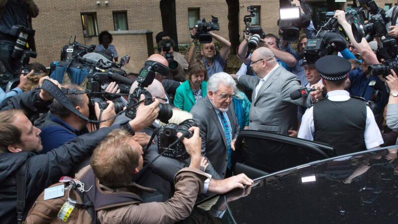 Rolf Harris  surrounded by the media as he leaves Southwark Crown Court. Photograph: Neil Hall/Reuters