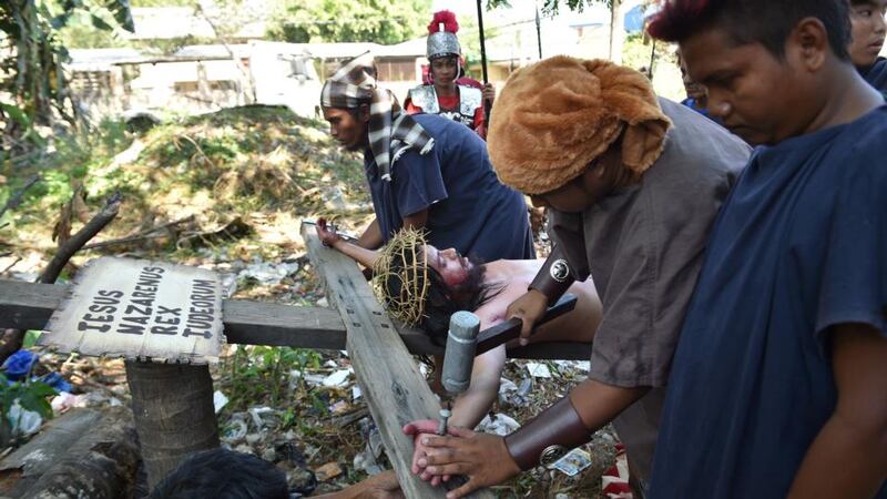 A penitent acting as Jesus is nailed to the cross as they re-enact the passion and death of Christ during Good Friday in Cainta town, Rizal province, east of Manila. Photograph: Ted Aljibe/AFP/Getty Images