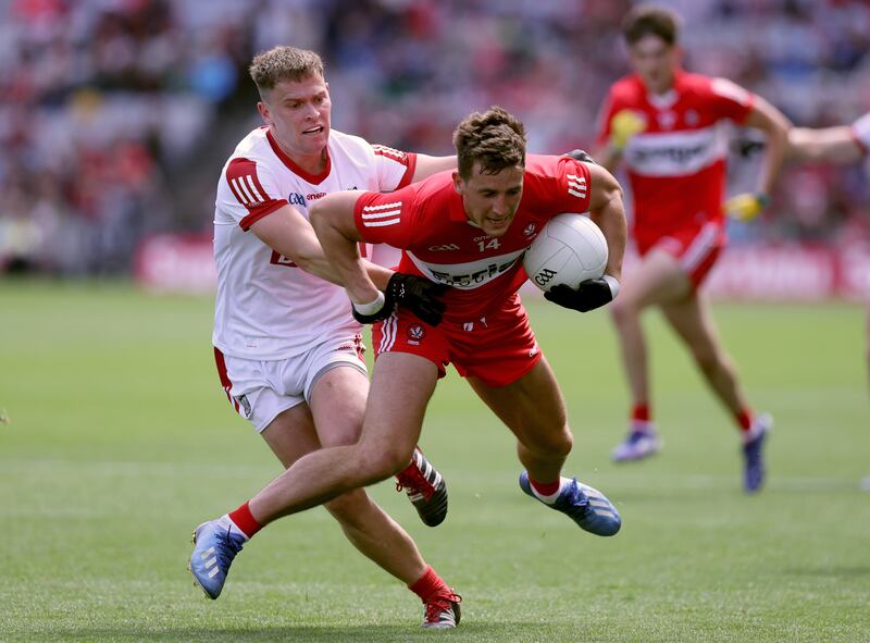 Derry's Shane McGuigan is tackled during the SFC quarter-final against Cork at Croke Park on Sunday. Photograph: John McVitty/Inpho