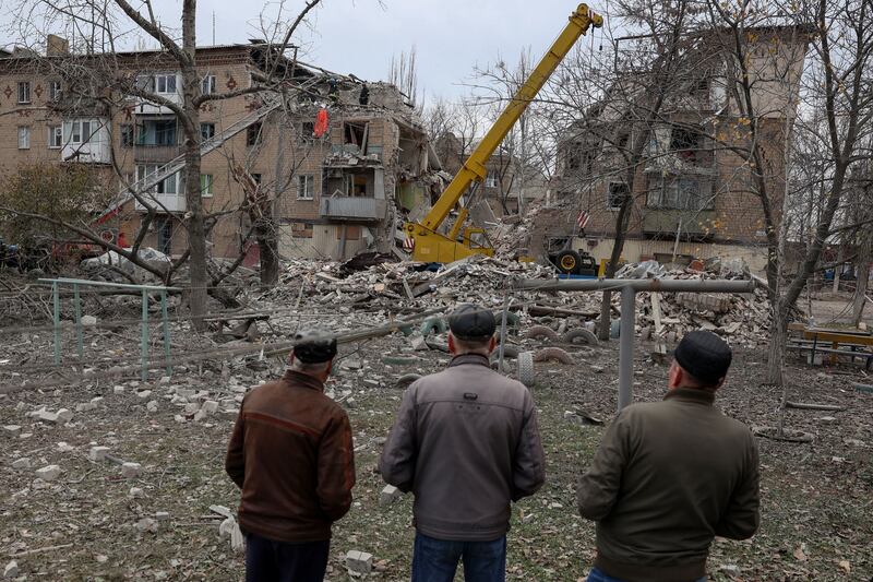 Local residents watch as rescue workers clear debris from a heavily damaged residential building following a Russian strike in the town of Selydove, Donetsk, on Wednesday. Photograph: Anatolii Stepanov/AFP via Getty
