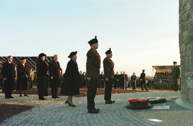 Queen Elizabeth pauses in front of the peace memorial during the ceremony watched by president Mary McAleese and King Albert of Belgium during the official opening of the Island of Ireland Peace Park at Mesen in Belgium. Photograph: Frank Miller