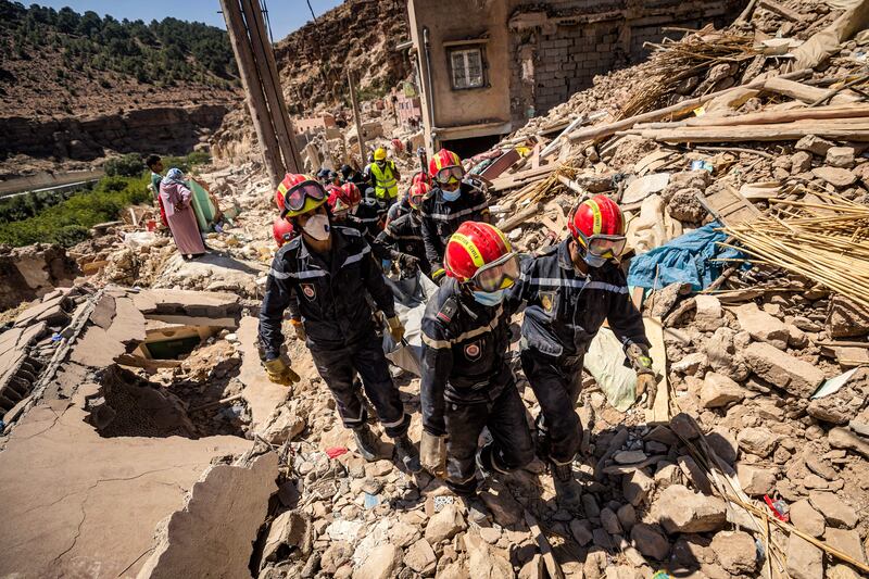 Rescue workers carry a body from the rubble of an earthquake-damaged house in Imi N'Tala village near Amizmiz, Morocco on Wednesday. Photograph: Fadel Senna/AFP via Getty