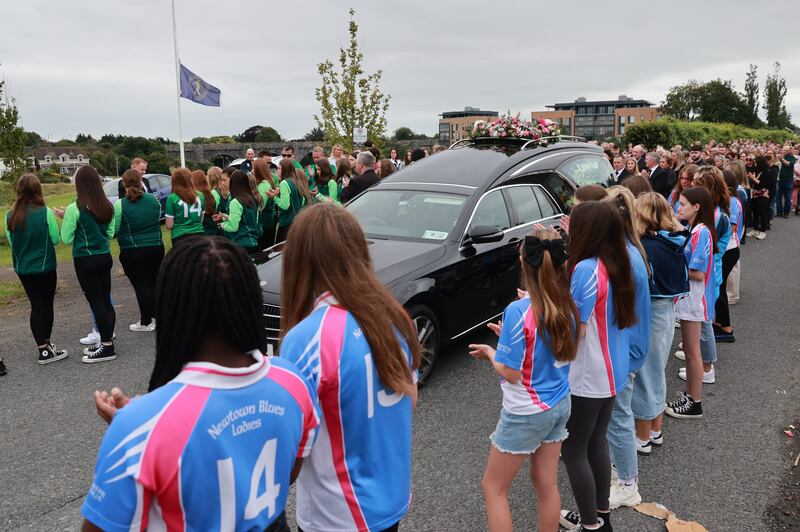 Members of Newtown Blues Ladies GFC and Termonfeckin Celtic FC applaud as the funeral cortege of Zara Murphy made its way to her funeral Mass in Drogheda on Tuesday. Photograph: Liam McBurney/PA Wire