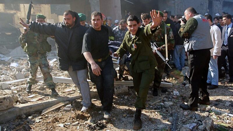 An injured victim is rushed from the scene of the car bombing that killed former prime minister Rafik Hariri and 21 others in Beirut in 2005. Photograph: Rorbert Schiller/The New York Times