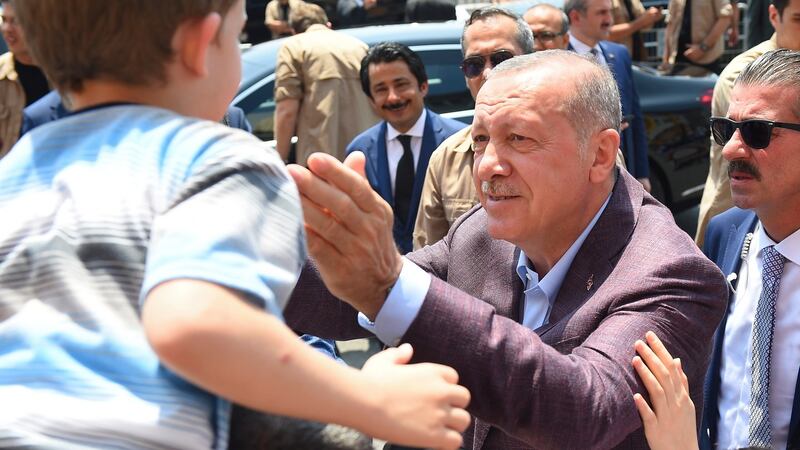 Turkish president Recep Tayyip Erdogan greets people after casting his vote during the Istanbul mayoral elections on Sunday. Photograph: EPA